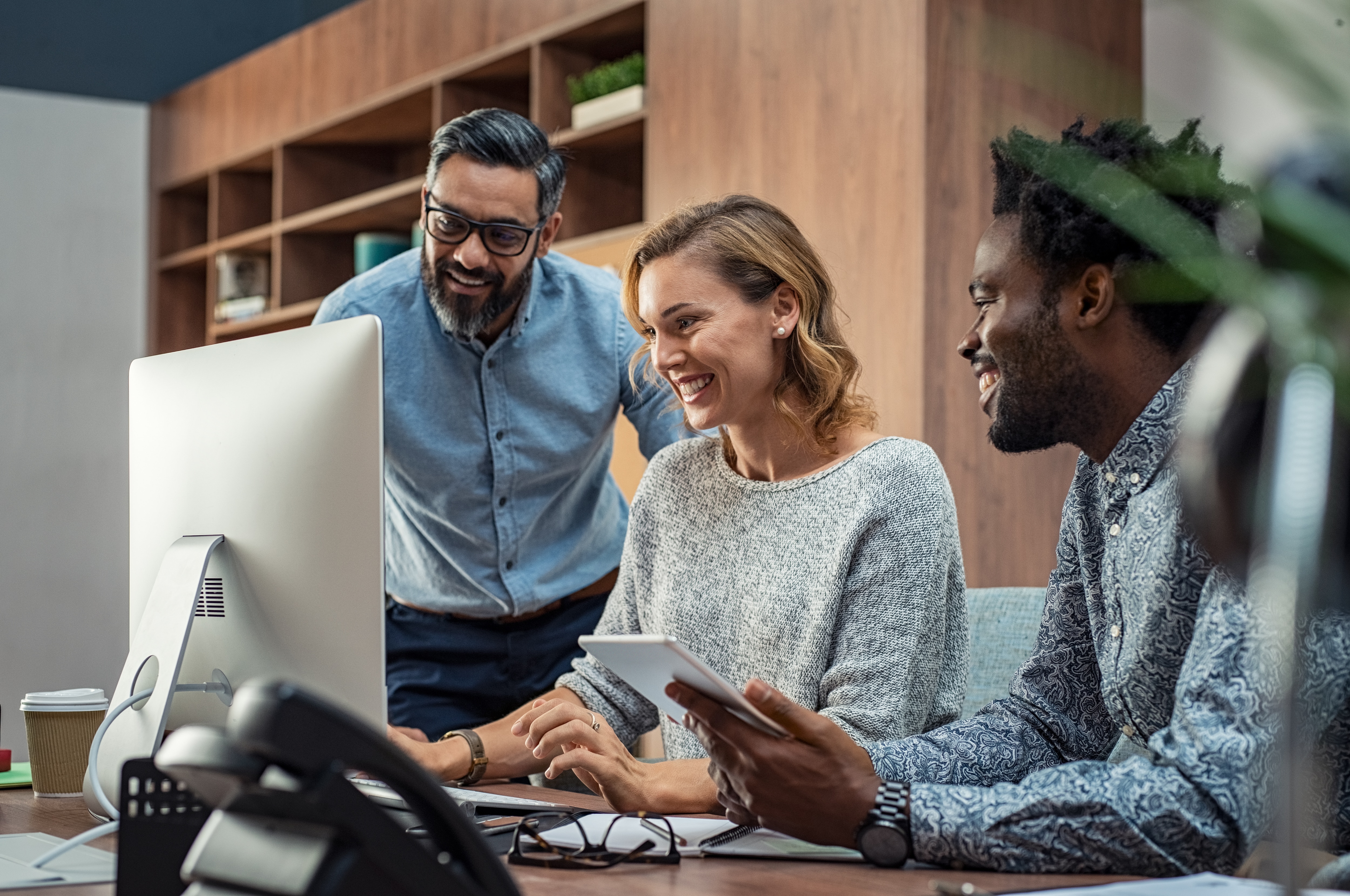 team gathered around a computer